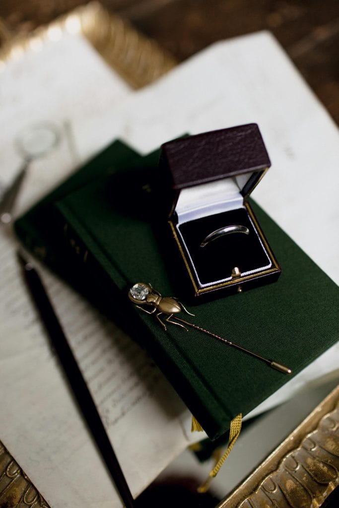 Valuation report beside a ring and gemstone tray