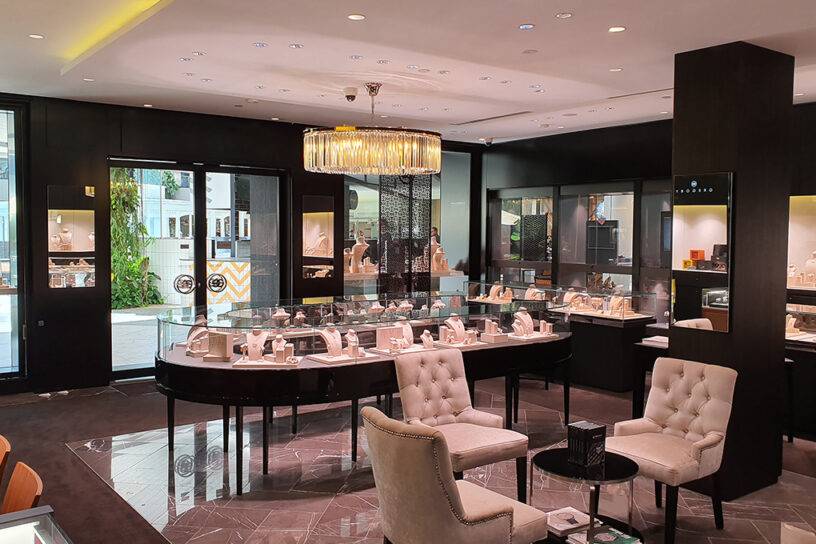 Elegant jewelry display at Jewellink, showcasing exquisite gold and diamond pieces in a luxurious store ambiance.